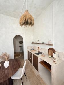 a kitchen with a table and a dining room at MEEY Suite with Private Spa in Saint-Étienne