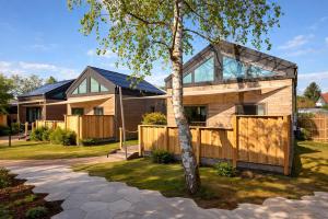 a house with a glass roof and a tree at SeeLaVie - Tiny Houses am Mattsee in Mattsee