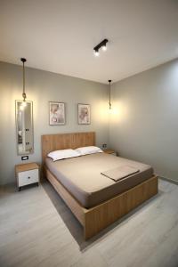 a bedroom with a large bed and a mirror at Julis Villa in Draç +12 photos