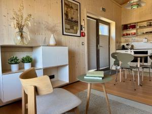 a kitchen and living room with a table and chairs at SeeLaVie - Tiny Houses am Mattsee in Mattsee