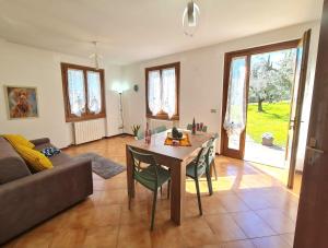 a living room with a table and chairs and a couch at Villa La Pief - Gardasee by Garda Domus Mea in Tremosine Sul Garda +42 photos
