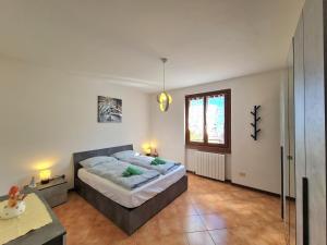 a bedroom with a large bed and a window at Villa La Pief - Gardasee by Garda Domus Mea in Tremosine Sul Garda