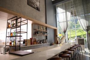 a bar with stools in a room with a window at Grand Suítes Family Resort in Itá