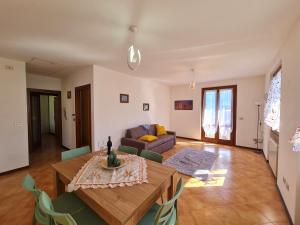 a living room with a table and a couch at Villa La Pief - Gardasee by Garda Domus Mea in Tremosine Sul Garda