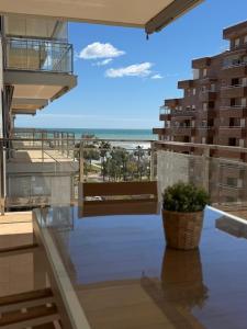 a view of the beach from the balcony of a building at Las Terrazas I - Primera línea de playa con Netflix, Disney plus y Prime Video in Oropesa del Mar