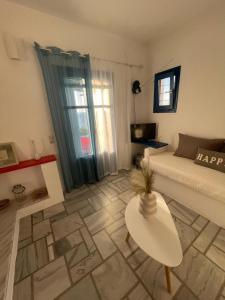 a living room with a couch and a table at Dejableu - Island Living Paros in Sarakíniko