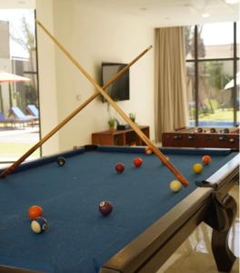 a pool table with balls on it in a living room at Atlantis The Palm Villa 2 in Al Rama
