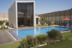 a swimming pool in front of a building at Atlantis The Palm Villa 2 in Al Rama