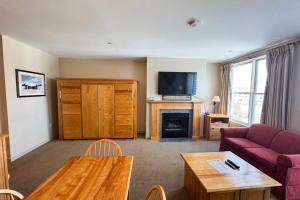 a living room with a couch and a fireplace at Long Trail House 459 in Stratton +19 photos