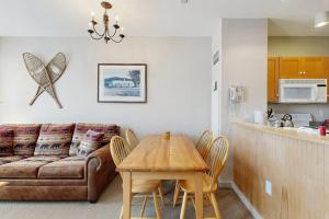 a living room with a couch and a table at Long Trail House 459 in Stratton