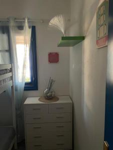 a bedroom with a dresser and a window and a shelf at Dejableu - Island Living Paros in Sarakíniko +33 photos