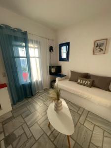a living room with a couch and a table at Dejableu - Island Living Paros in Sarakíniko