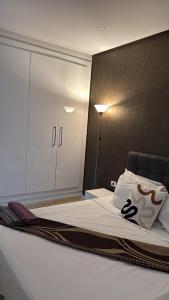 a bedroom with a large bed with a closet at Le Chill Out in Tunis