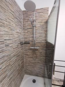 a bathroom with a shower with a glass door at Le Chant des Grenouilles in Itteville +12 photos