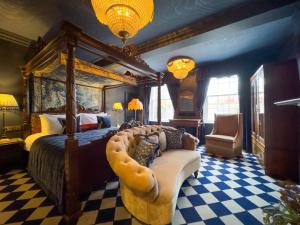 a bedroom with a bed and a couch in a room at Guy Fawkes Inn in York