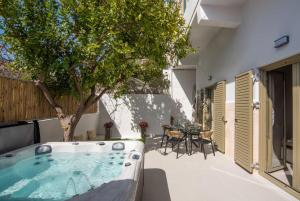 a hot tub in the backyard of a house at Joanna Holiday Home in Egina