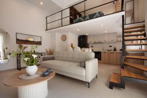 a living room with a couch and a table at Joanna Holiday Home in Egina
