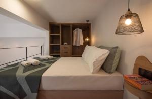 a bedroom with a bed with two towels on it at Joanna Holiday Home in Egina