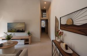 a living room with a table and a couch at Joanna Holiday Home in Egina