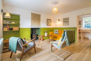 a living room with a couch and a table at 4 Low Rake - Former Miners Cottage in Glenridding