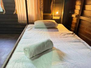 a bed with two pillows on top of it at Belvilla Baan Elephant Home in Chiang Mai +46 photos