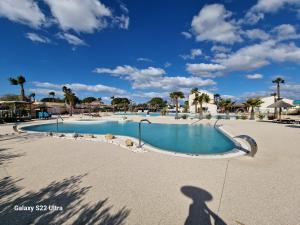 a shadow of a person standing in front of a swimming pool at Valras Jasmin 68 in Sérignan +11 photos