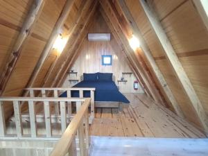 a bedroom in a attic with a blue bed at ByDamla Bungalov in Sapanca +44 photos