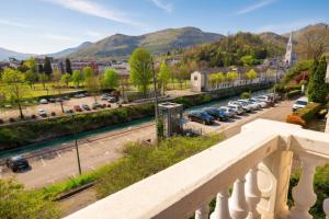 a balcony with a view of a parking lot at Villa l'Orante in Lourdes