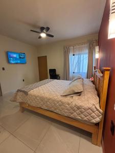 a bedroom with a bed and a ceiling fan at La Estancia de Rey David in San Luis Potosí