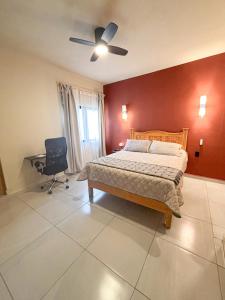 a bedroom with a bed and a ceiling fan at La Estancia de Rey David in San Luis Potosí