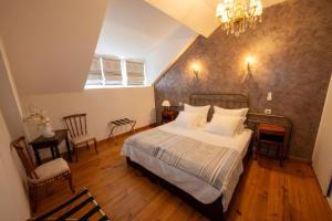 a bedroom with a bed and a table and chairs at Villa l'Orante in Lourdes