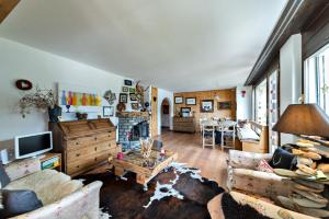 a living room with a couch and a table at Chesa Flurigna - Zuoz in Zuoz