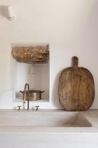 a kitchen counter with a sink and a wooden pumpkin at Oxalis Villas in Perlengiánika +88 photos