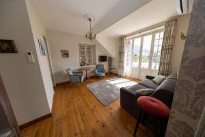 a living room with a couch and a table at Villa l'Orante in Lourdes
