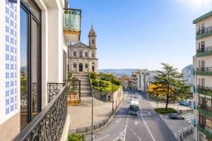 a view from a balcony of a street with a church at FindMe InPorto Bonfim in Porto