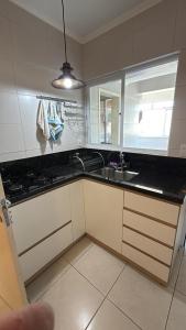 a kitchen with a sink and a counter top at Apto Dangui Amplo in Santa Maria