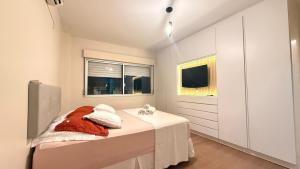 a bedroom with a bed and a television in it at Apto Dangui Amplo in Santa Maria