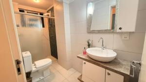 a white bathroom with a sink and a toilet at Apto Dangui Amplo in Santa Maria