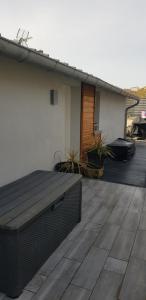 a deck with a bench on a house at Maison des dunes in Berck-sur-Mer