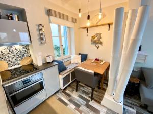 a kitchen and dining room with a wooden table in a room at Apollo House in Lefkada