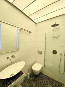 a bathroom with a sink and a toilet at Apollo House in Lefkada +33 photos