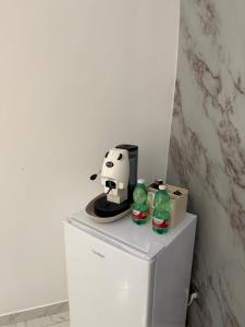 a hello kitty coffee maker and soda bottles on top of a refrigerator at Fly Home 2 in Naples