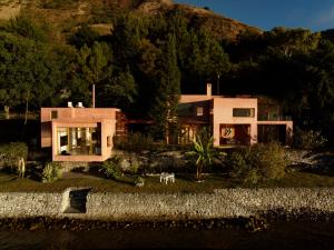 a house on the side of a mountain at Anzan Atitlan in San Marcos La Laguna