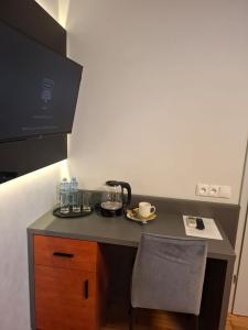 a counter with a coffee maker on it with a chair at Ambrozja in Strzelin