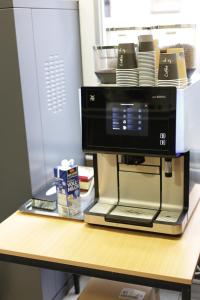 a coffee maker sitting on top of a table at Pension Alpha in Frankfurt