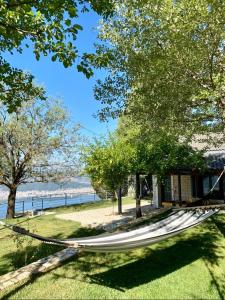 a hammock on the grass near the water at Ktima Papadimitriou in Ioannina