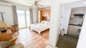 a bedroom with a bed and a kitchen in a room at Apartments Antonio in Tisno