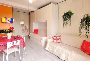a living room with a couch and a table at Appartamenti Foyer in Bibione