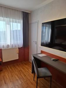 a room with a desk with a chair and a mirror at Ambrozja in Strzelin +44 photos