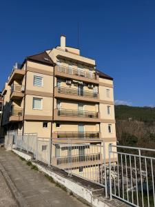 a tall building with a fence in front of it at River Park Oasis apartment in Sandanski